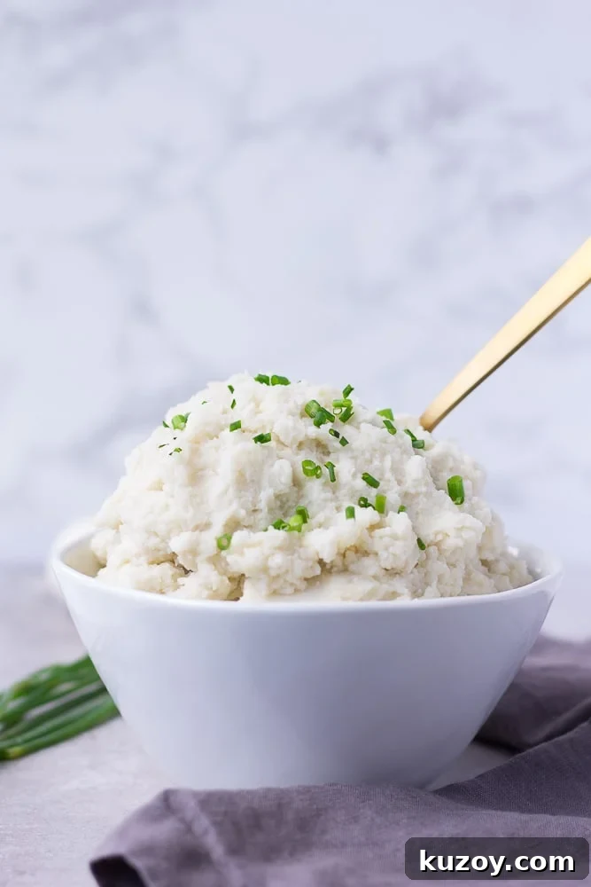 instant pot mashed potatoes from the side in a bowl, gray background
