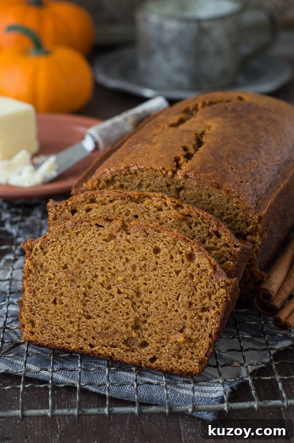 Copycat Starbucks Pumpkin Bread Recipe: Moist Loaf with Spices 3 pumpkin bread loaf sliced into 2 pieces on metal cooling rack