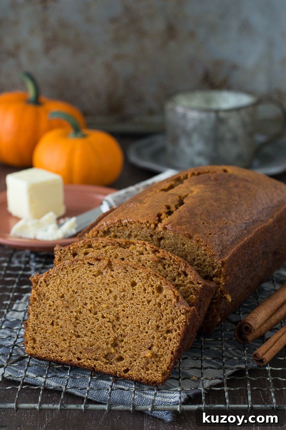 Copycat Starbucks Pumpkin Bread Recipe: Moist Loaf with Spices 7 pumpkin bread loaf sliced into 2 pieces on metal cooling rack
