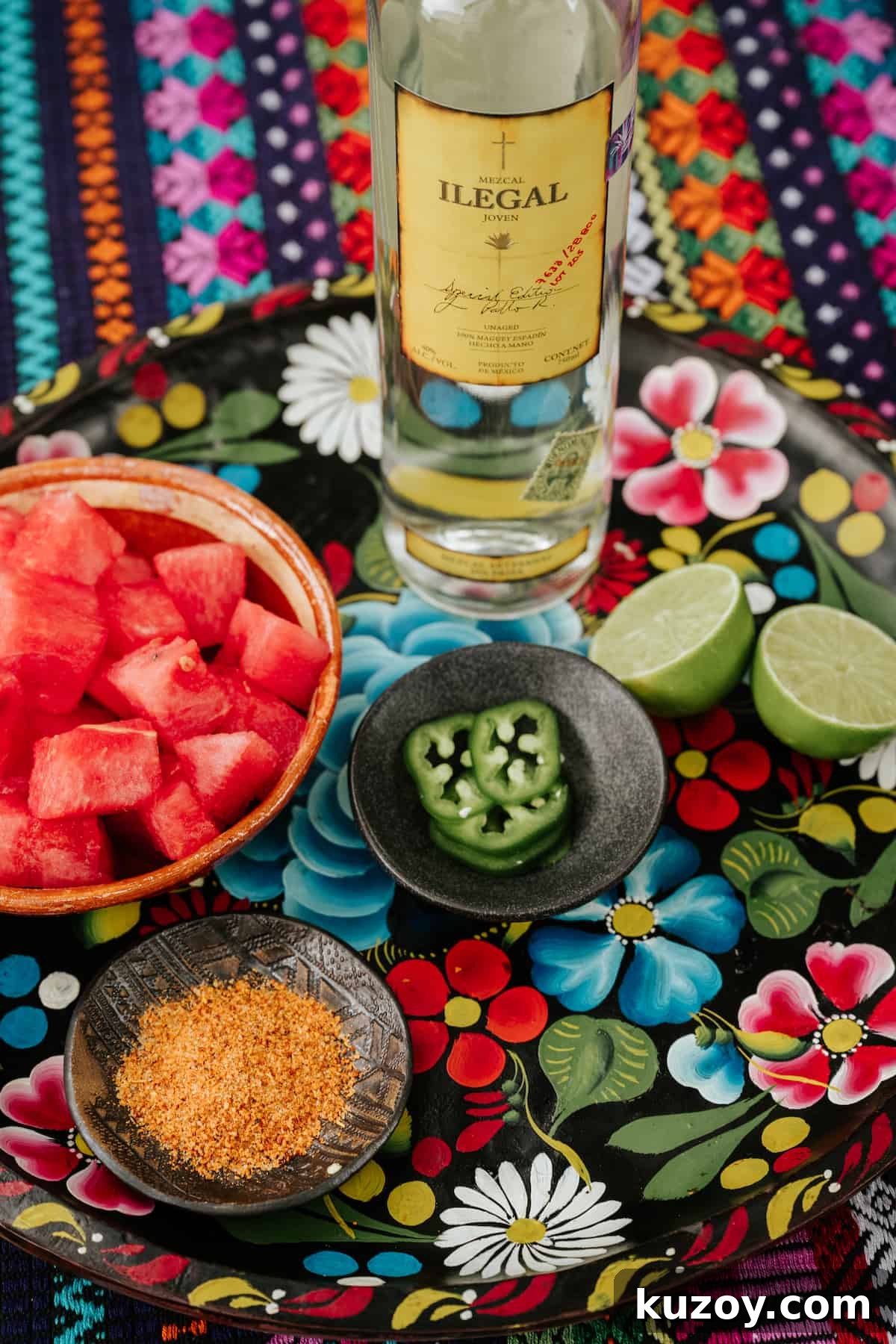 Spicy Jalapeño Watermelon Mezcal Margarita Recipe 3 ingredients needed to make a spicy mezcal margarita with jalapeno and watermelon measured out on a hand-painted floral tray.