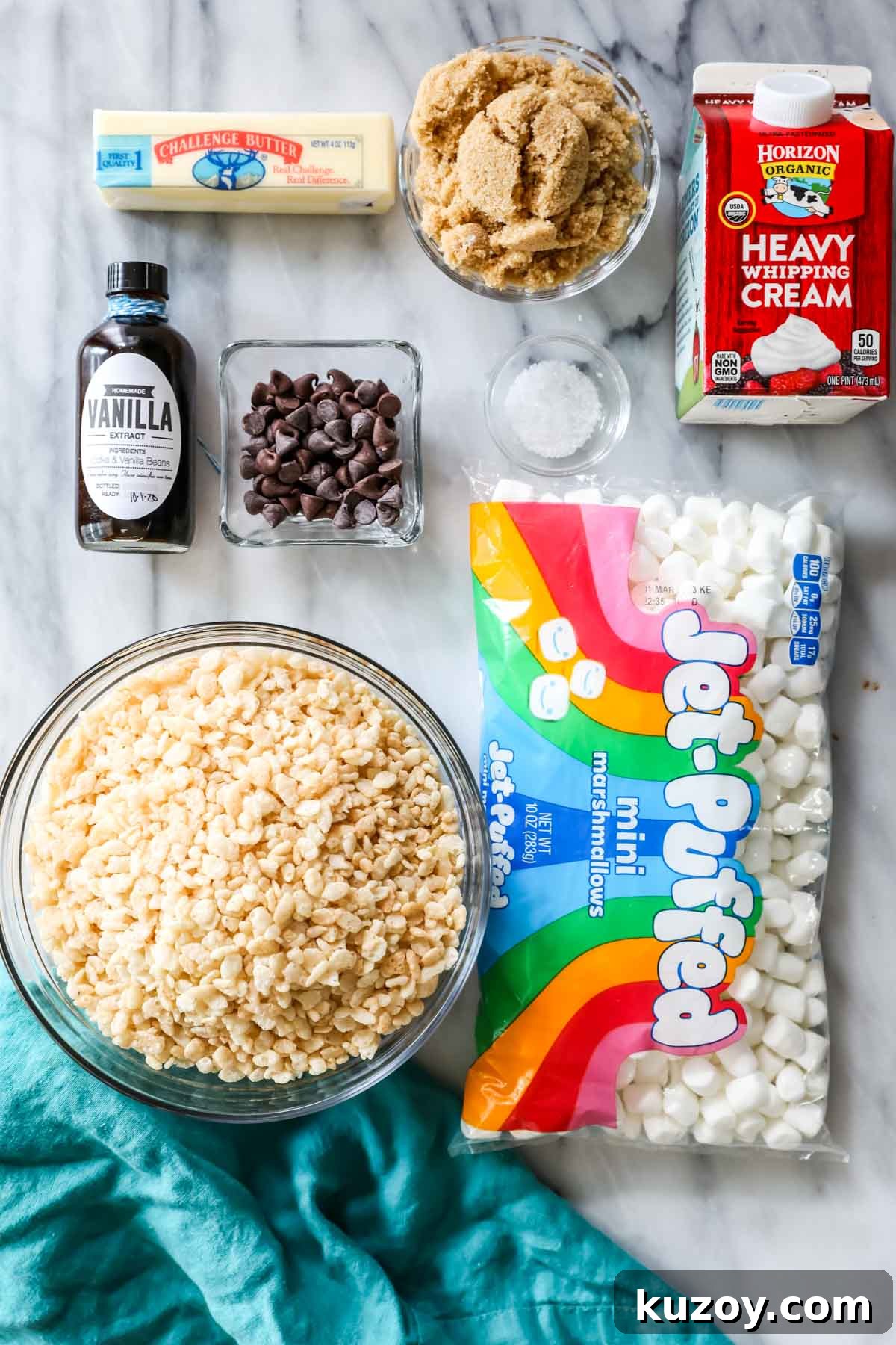 Overhead view of ingredients including rice krispies cereal, marshmallows, brown sugar, cream, and more.