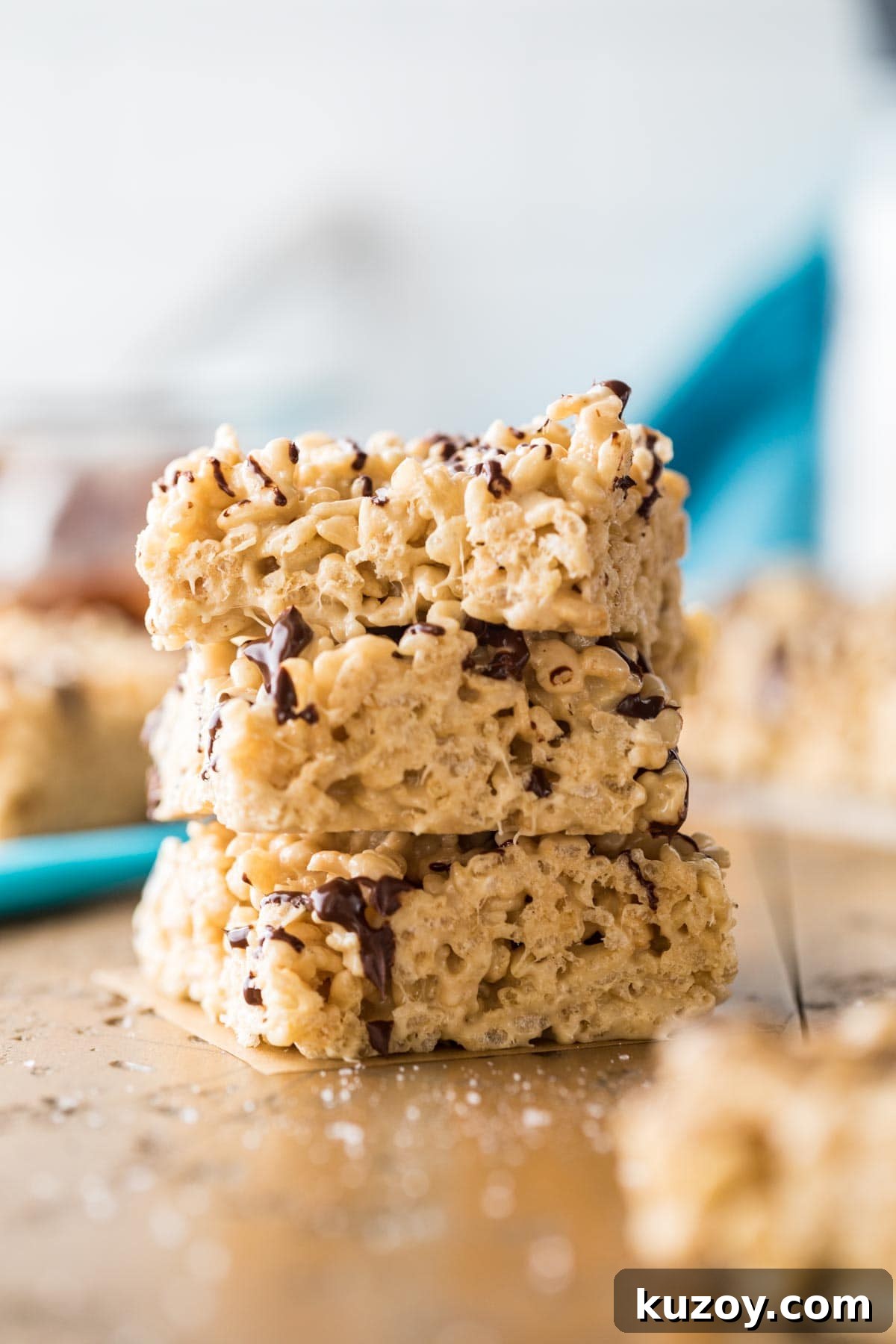 Three stacked salted caramel rice krispie treats.