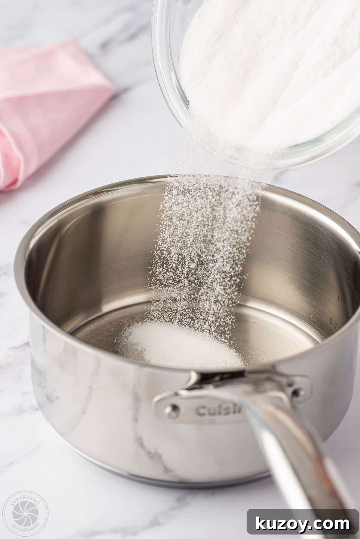 How to Make Smooth Homemade Caramel Sauce for Desserts 11 Pouring granulated sugar into a pan.