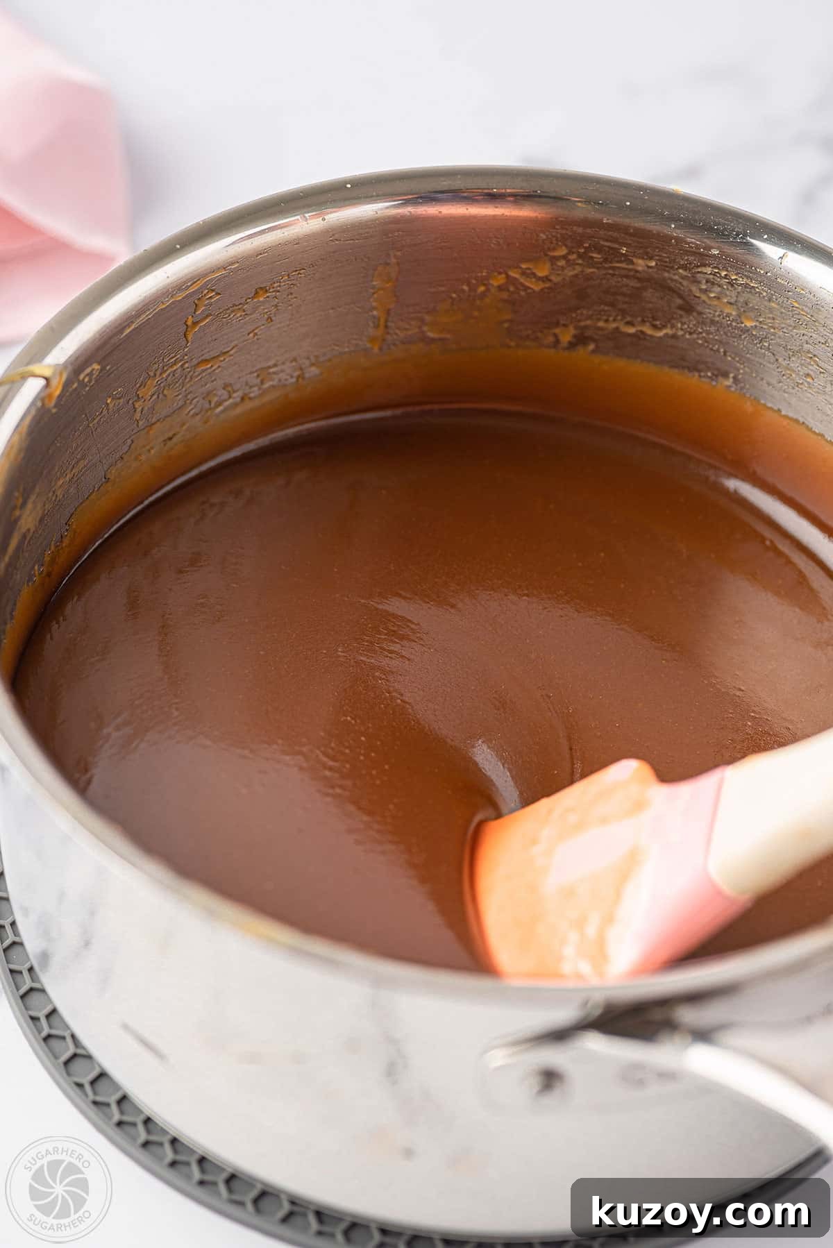 How to Make Smooth Homemade Caramel Sauce for Desserts 15 A pot with golden caramel.