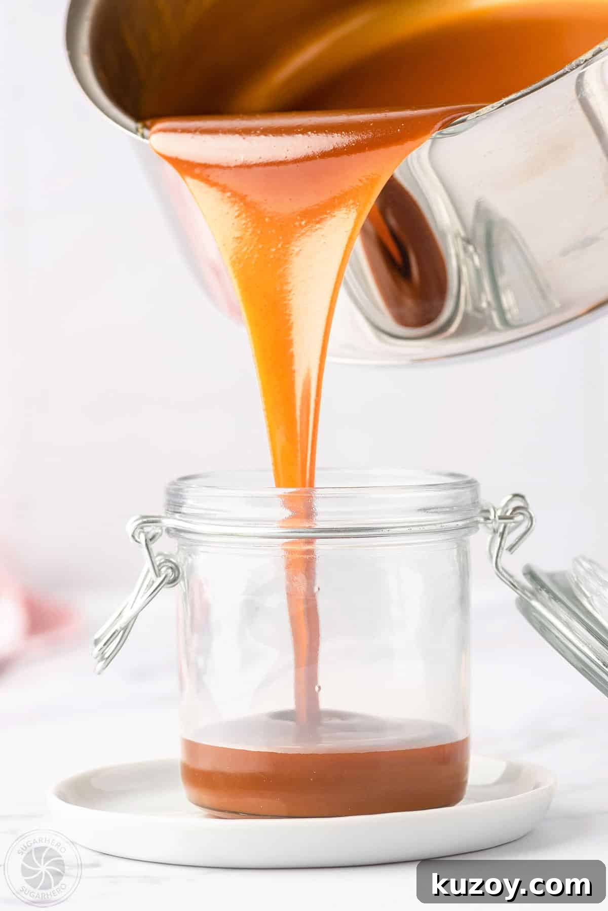 How to Make Smooth Homemade Caramel Sauce for Desserts 5 Pouring caramel sauce from the saucepan into a glass jar.