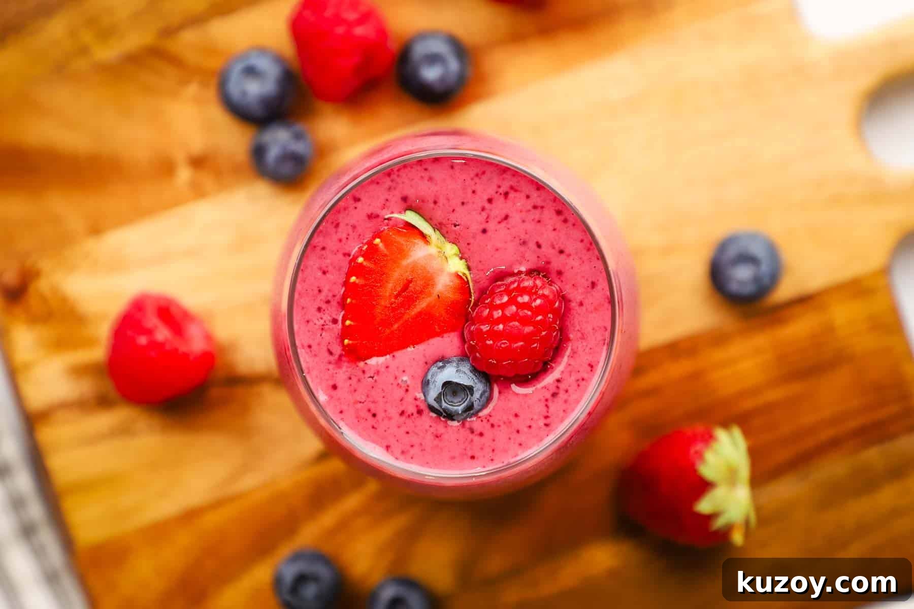 an overhead shot of triple berry smoothie in a glass