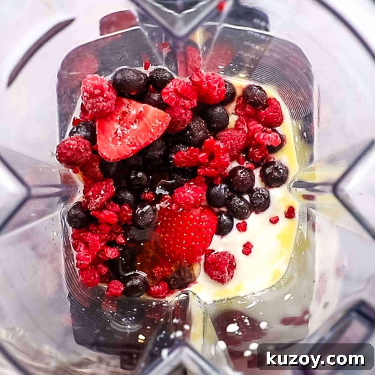 triple berry smoothie ingredients in a blender