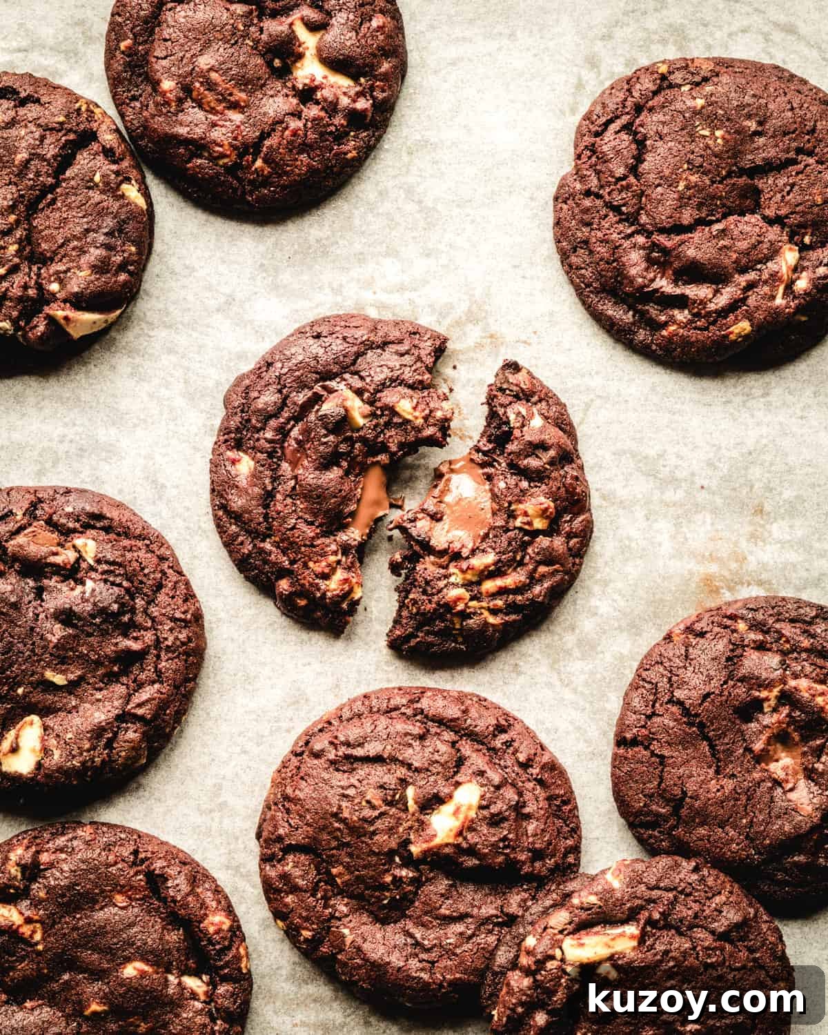 freshly baked white chocolate chocolate cookies on a piece of parchment paper