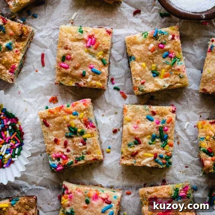 sugar cookie bars with funfetti sprinkles on a piece of parchment paper