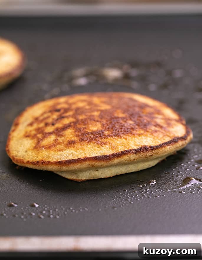 Cooked pancake on hot skillet.