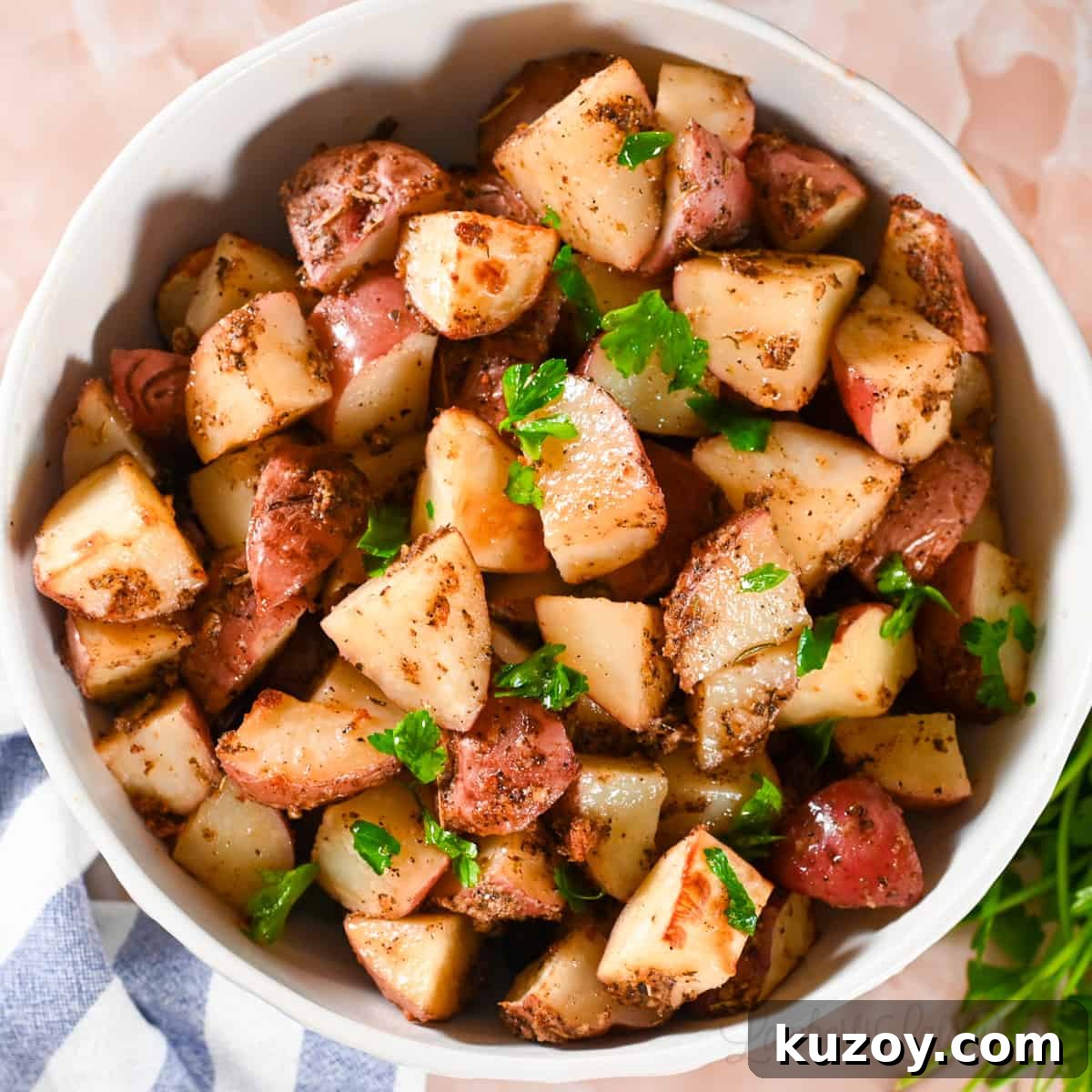 roasted red potatoes in a large bowl, garnished with parsley.