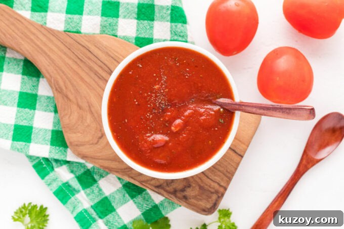 Homemade Pizza Sauce Without Tomato Paste — Fresh & Flavorful 7 Bowl of pizza sauce on a cutting board.