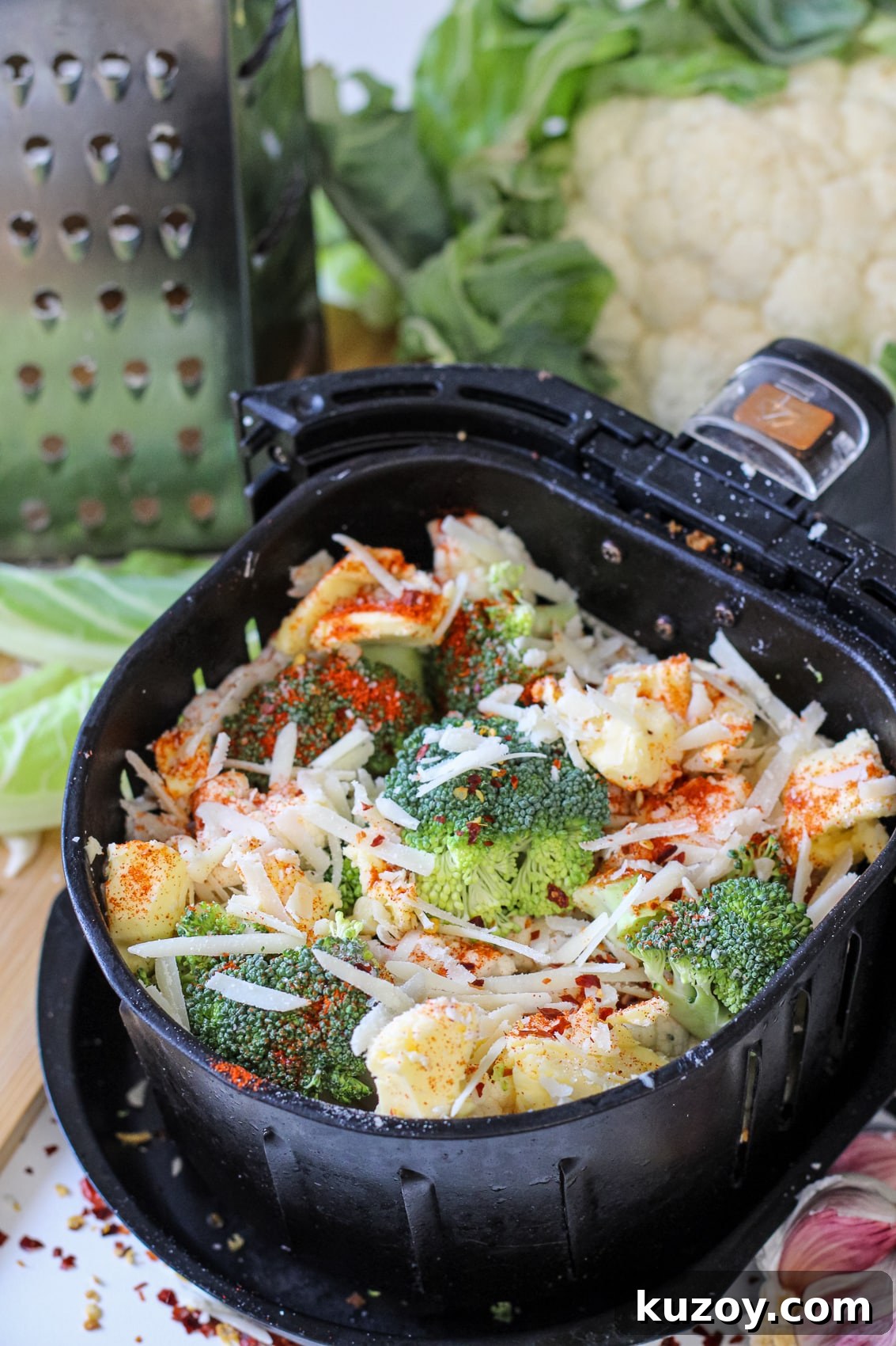 fresh broccoli and cauliflower in air fryer basket