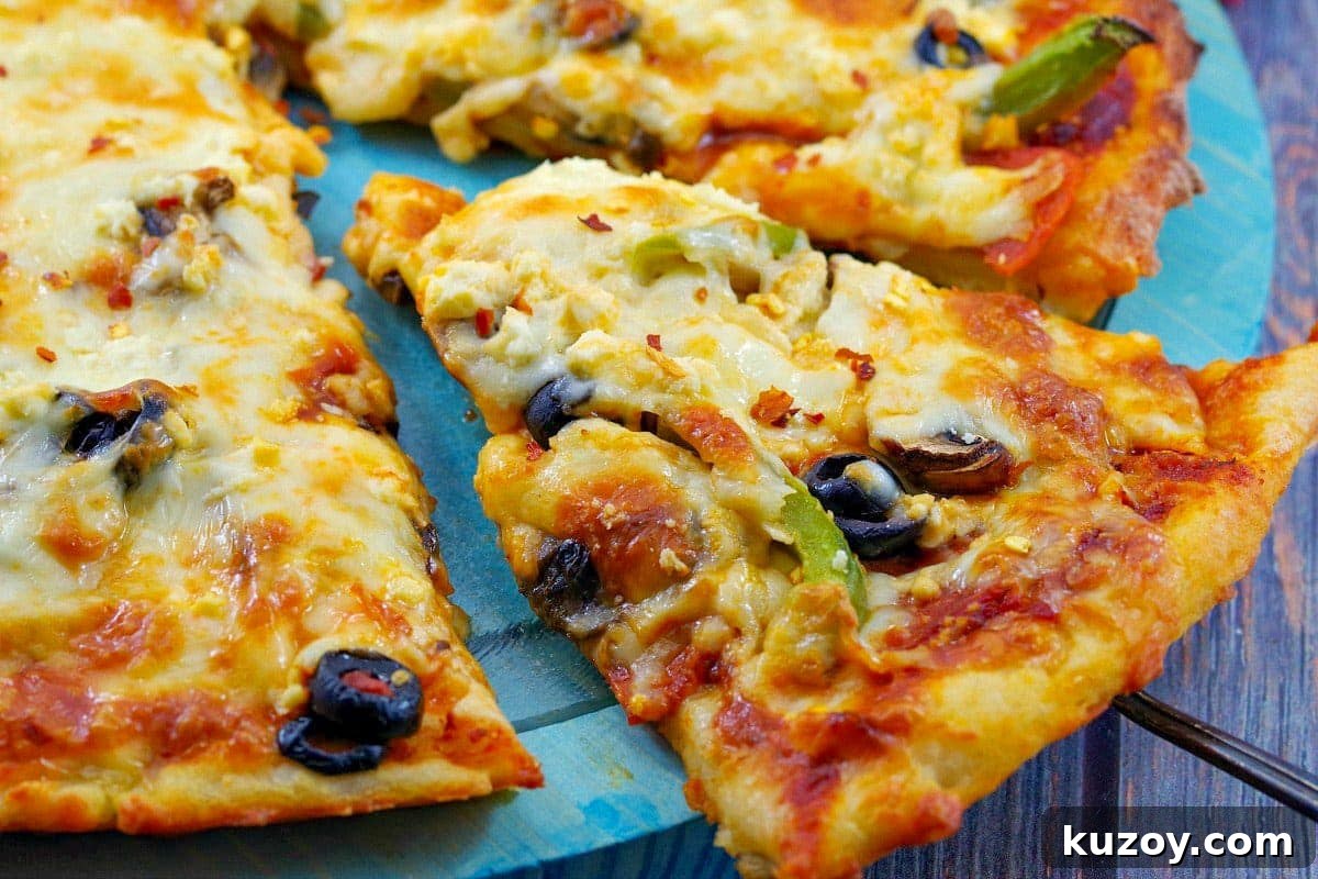 Weight Watchers Pizza Recipe with 2-Ingredient Dough 2 slice of weight watchers pizza being lifted off a blue pizza plate