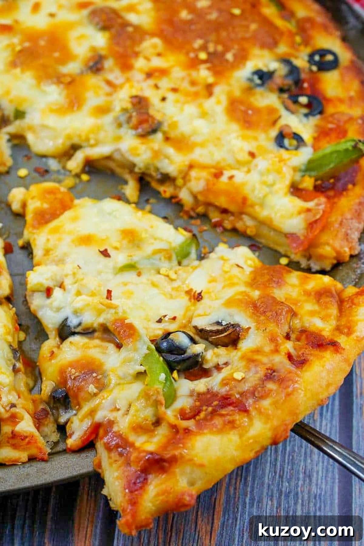 Weight Watchers Pizza Recipe with 2-Ingredient Dough 7 A slice of ww pizza being lifted of a pizza pan