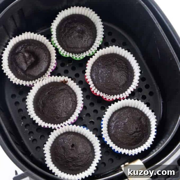 Air Fryer Chocolate Lava Mug Cake Recipe 14 Six chocolate cupcakes in an air fryer basket.