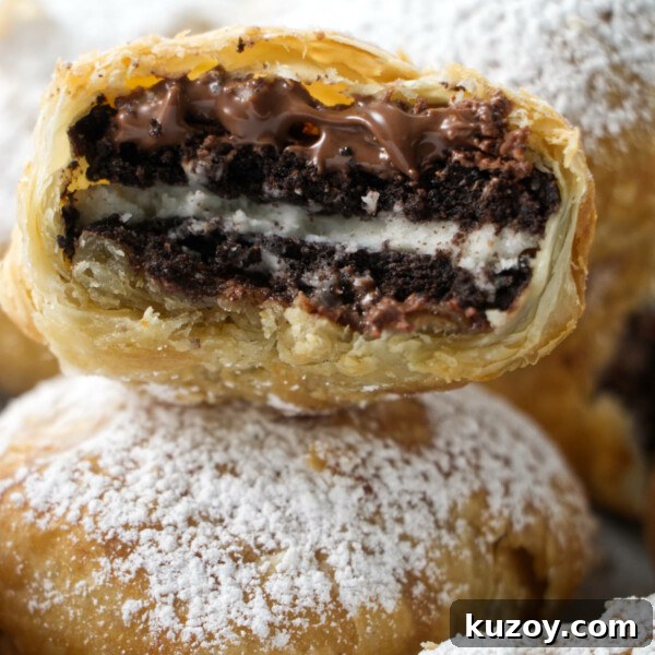 Air Fryer Chocolate Lava Mug Cake Recipe 18 stack of air fried oreos with one in the middle that has been bitten into with nutella oozing out and a crumbly puff pastry shell.