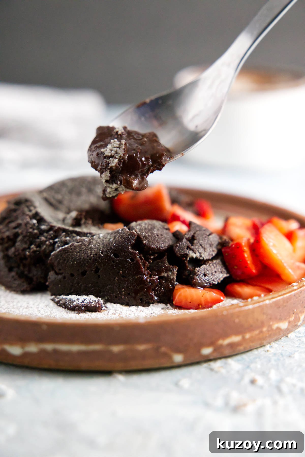 Air Fryer Chocolate Lava Mug Cake Recipe 3 Spoonful of chocolate lava cake with gooey ganache center.