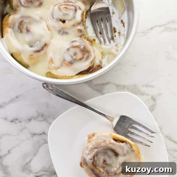 Air Fryer Chocolate Lava Mug Cake Recipe 22 Five cinnamon rolls in a cake pan and one on a plate.