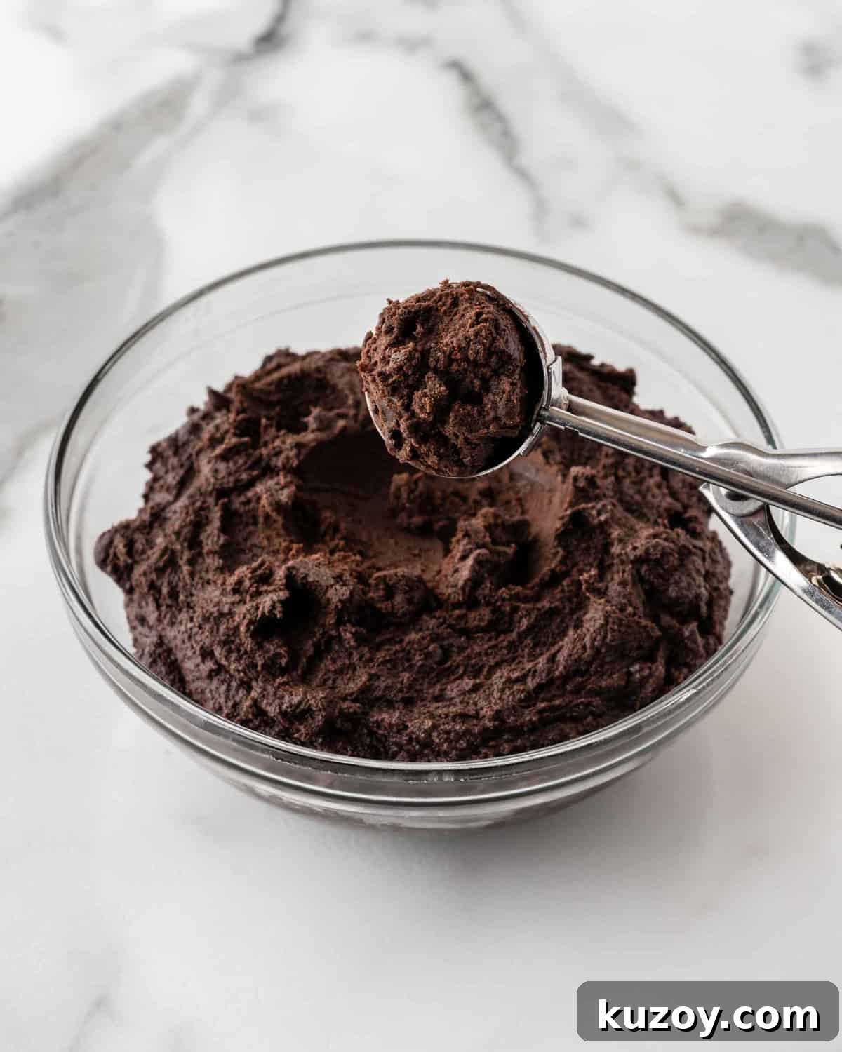 bowl of oreo truffle dough with cookie scoop