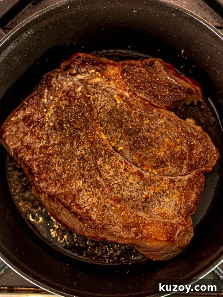 Well-browned chuck roast in a pan.