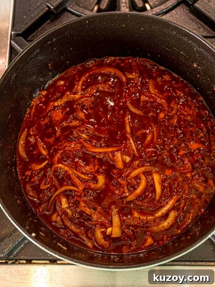 Onions and garlic simmering in a rich tomato and red wine sauce.