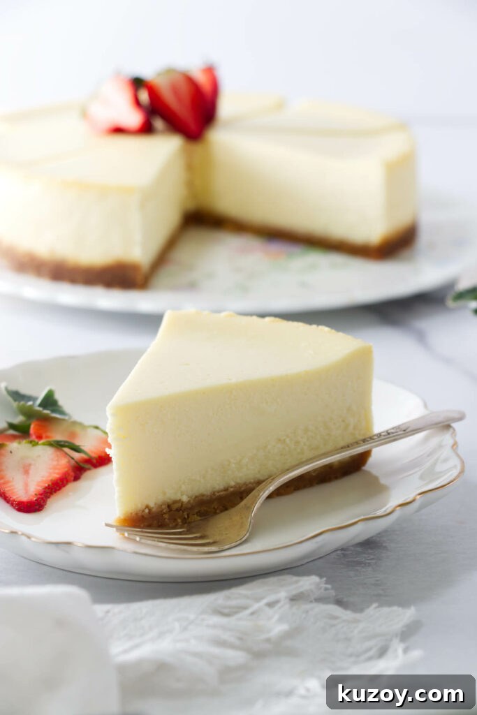 Slice of cheesecake baked with no water bath, whole cake in background.