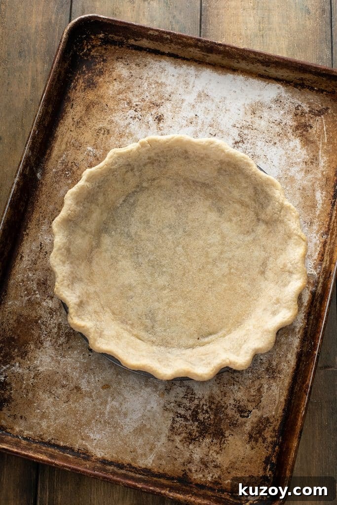 Decadent Chocolate Pecan Pie with Gooey Filling 9 Baked pie crust in a pie dish over a baking tray