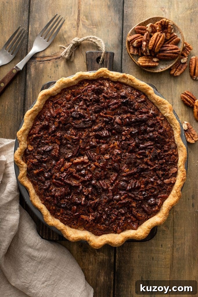 Decadent Chocolate Pecan Pie with Gooey Filling 11 Top view of a baked chocolate pecan pie with golden brown edges.