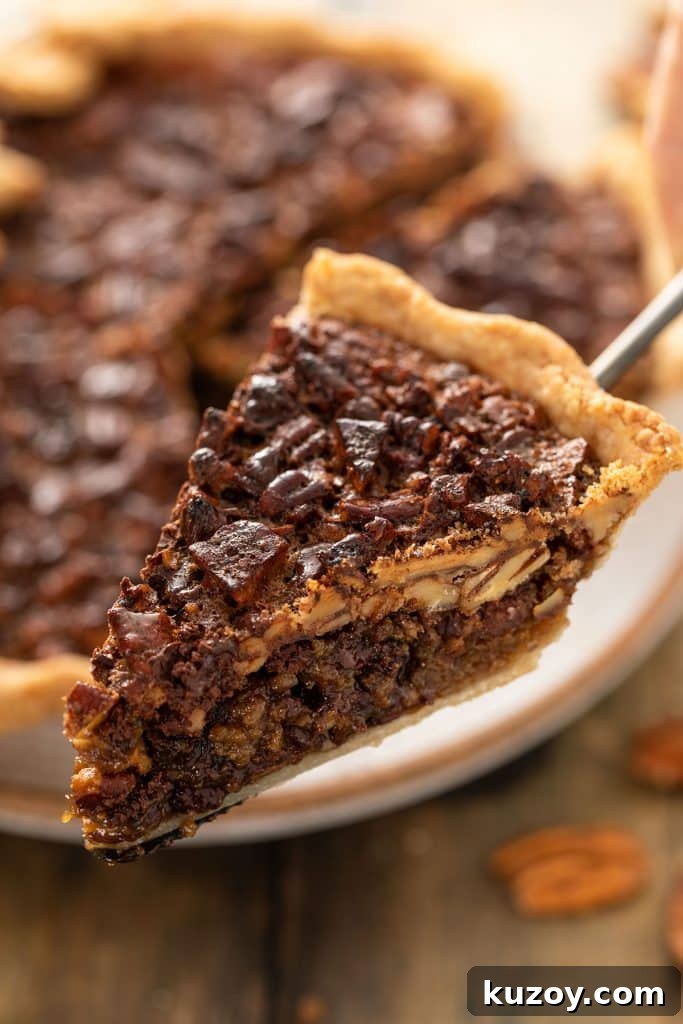 Decadent Chocolate Pecan Pie with Gooey Filling 12 Close up view of a slice of Chocolate Pecan Pie