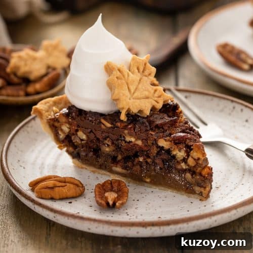 Decadent Chocolate Pecan Pie with Gooey Filling 14 A slice of decadent chocolate pecan pie topped with whipped cream