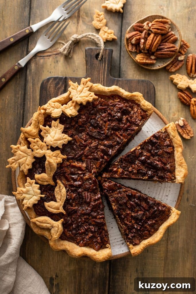 Decadent Chocolate Pecan Pie with Gooey Filling 3 Top view of a Chocolate Pecan Pie with a few pieces cut out.