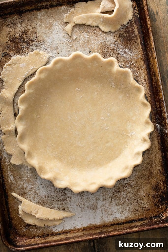 Decadent Chocolate Pecan Pie with Gooey Filling 6 pie crust dough folded perfectly into the pie dish.