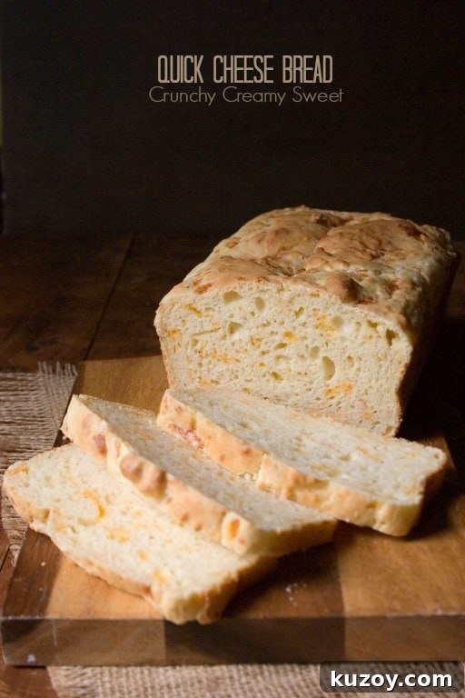 Forget plain bread - this Quick Cheese Bread is perfect for sandwiches or toasted and paired with soup! Side shot of cheese bread with few slices down on cutting board.