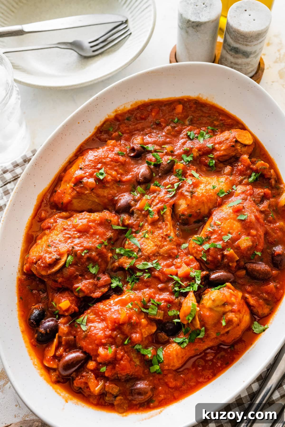 Authentic Chicken Cacciatore Recipe: Classic Italian Stew 2 cooked chicken cacciatore recipe in a platter with fresh parsley on top.