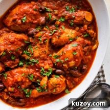 Authentic Chicken Cacciatore Recipe: Classic Italian Stew 20 cooked chicken cacciatore recipe in a platter with fresh parsley on top.
