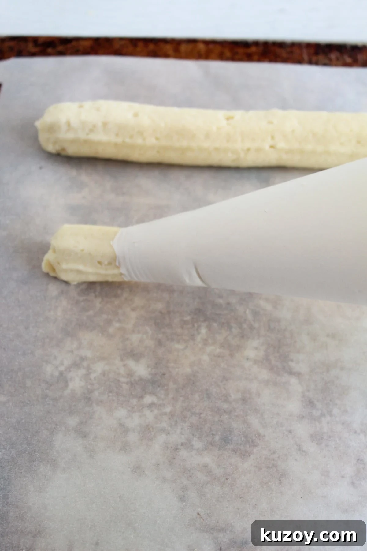 Gluten-Free Breadsticks Recipe That Will Impress Everyone 11 piping breadsticks on a pan.