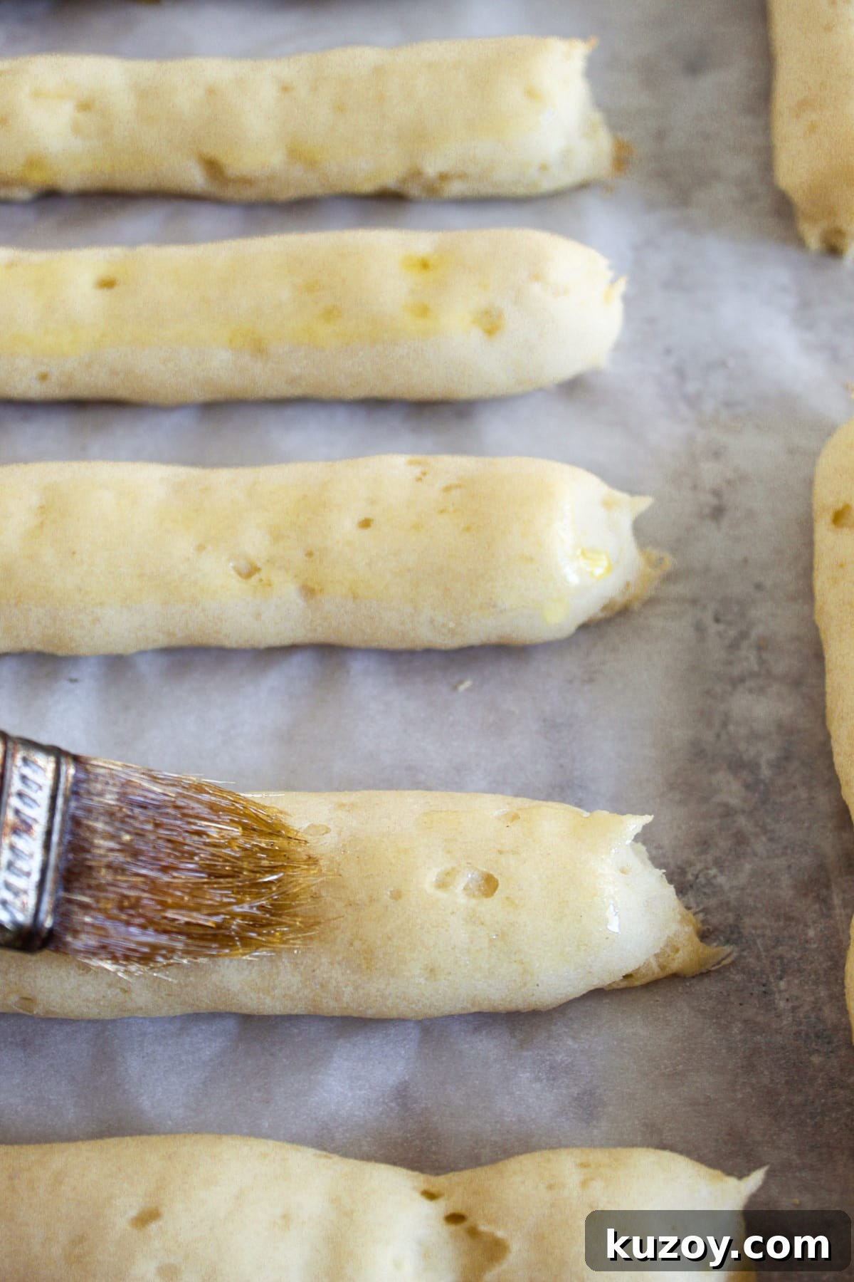 Gluten-Free Breadsticks Recipe That Will Impress Everyone 13 brushing baked breadsticks with olive oil