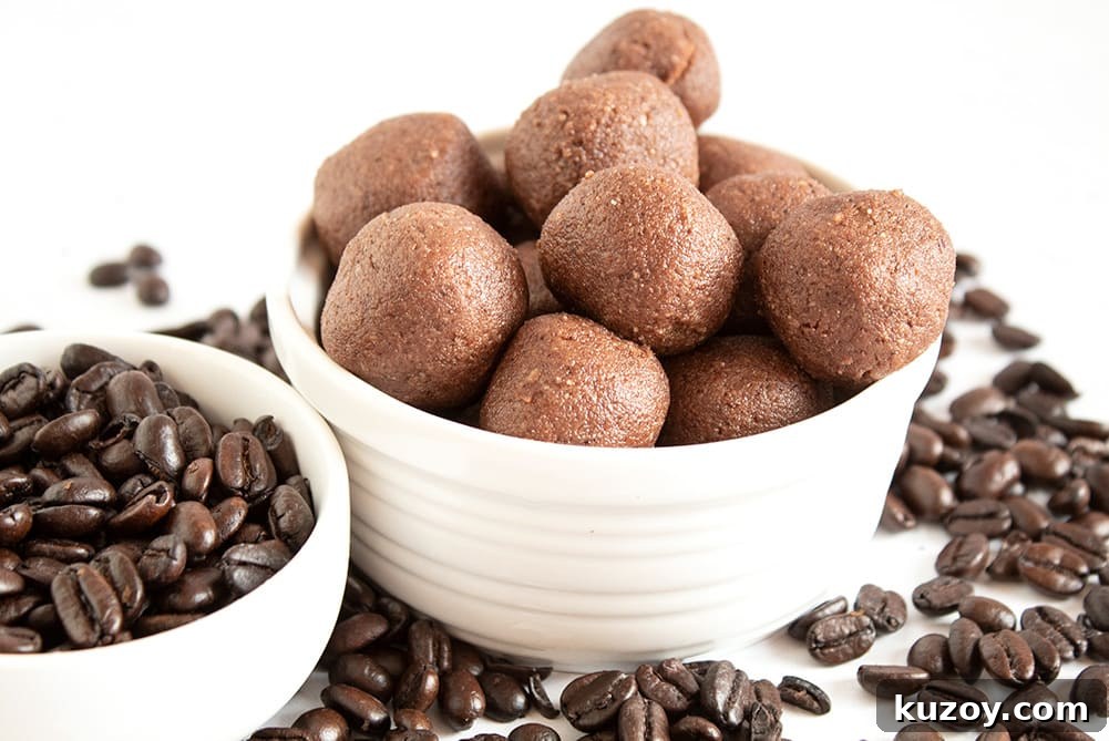 Caffeinated Keto Chocolate Coffee Fat Bombs for Energy 2 keto chocolate coffee fat bombs in a white dish next to dish of coffee beans