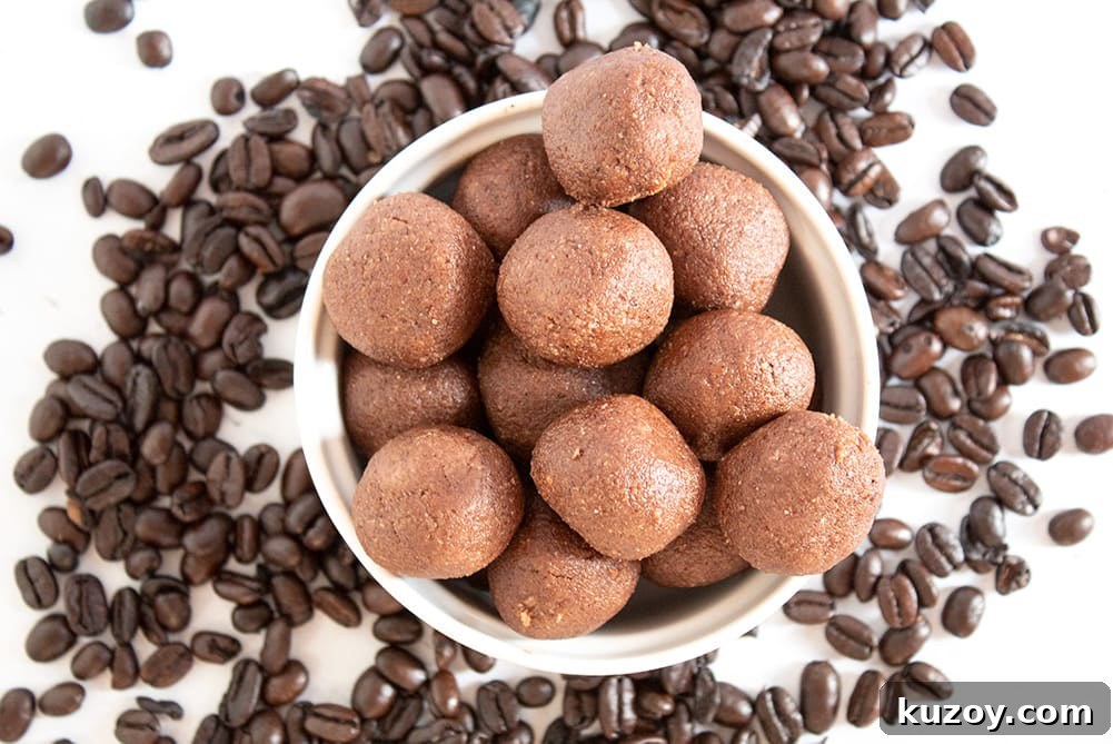 Caffeinated Keto Chocolate Coffee Fat Bombs for Energy 6 keto chocolate coffee fat bombs in a white bowl with coffee ground scattered about
