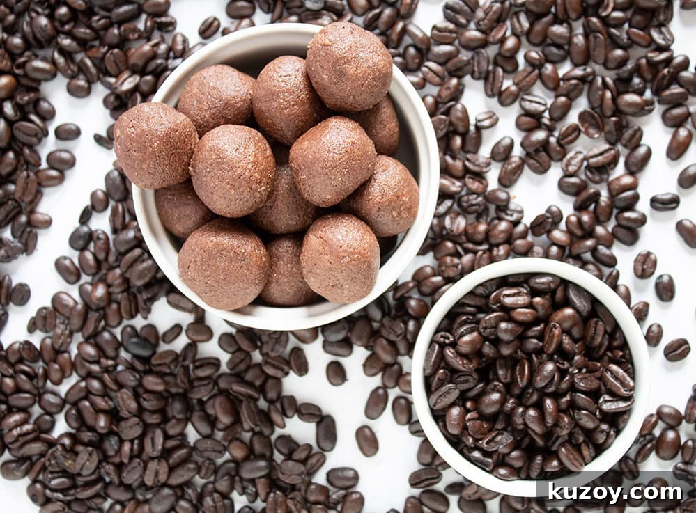 Caffeinated Keto Chocolate Coffee Fat Bombs for Energy 7 keto chocolate fat bombs in a bowl surrounded by coffee beans on countertop