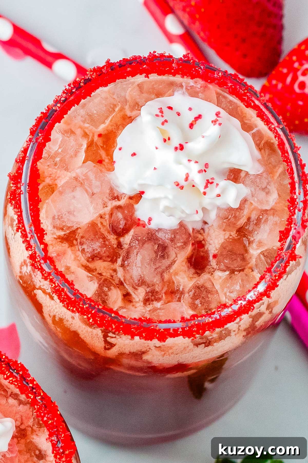 Swig Spring Fling Copycat Drink Recipe for Valentine’s Day 2 Strawberry dirty Dr Pepper drink with pebble ice and whipped cream, garnished with red sugar rim and surrounded by fresh strawberries.