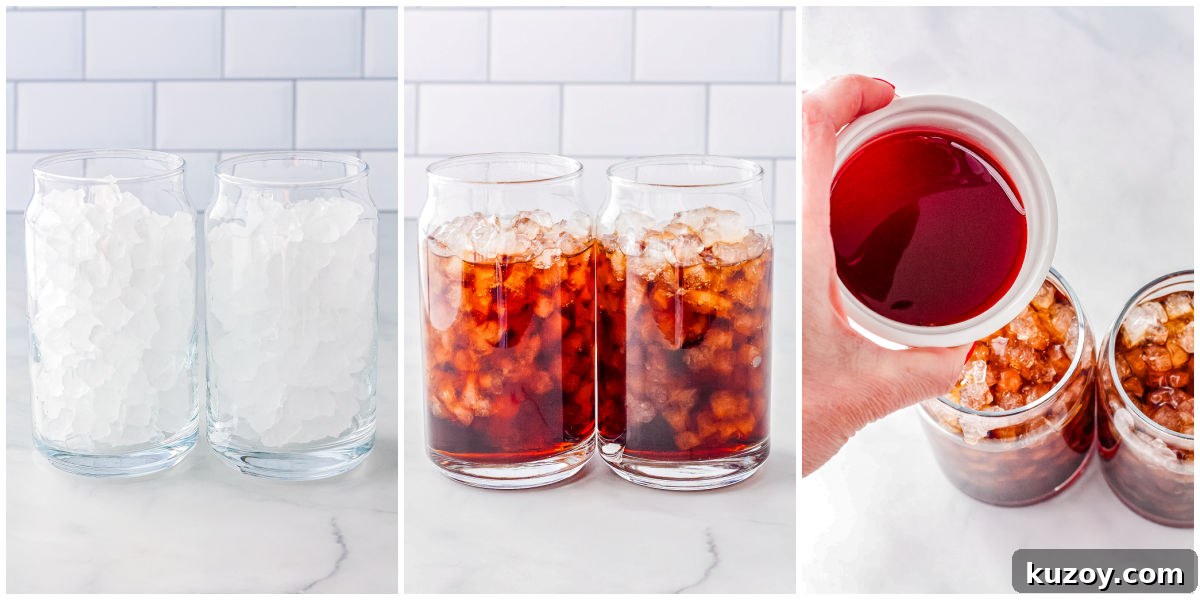 Swig Spring Fling Copycat Drink Recipe for Valentine’s Day 4 Clear glasses filled with pebble ice as Dr Pepper is poured in, showing the base of a strawberry coconut dirty soda.