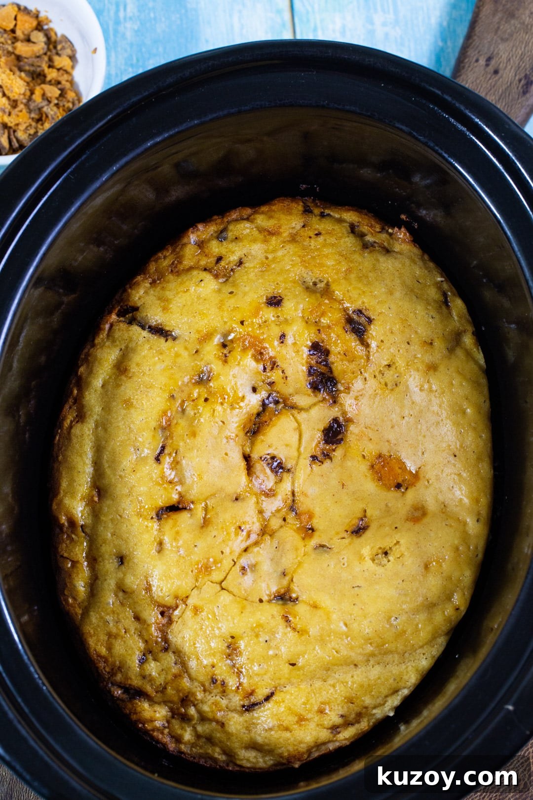 Slow Cooker Butterfinger Cake Recipe for Gooey Chocolate-Peanut Butter Delight 3 Unfrosted cake in slow cooker.