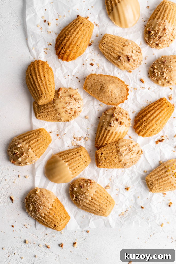 Maple Chai Madeleines Recipe: Spiced Tea-Infused French Cookies 3 maple chai spiced madeleines dipped in a maple glaze and sprinkled with crushed pecans