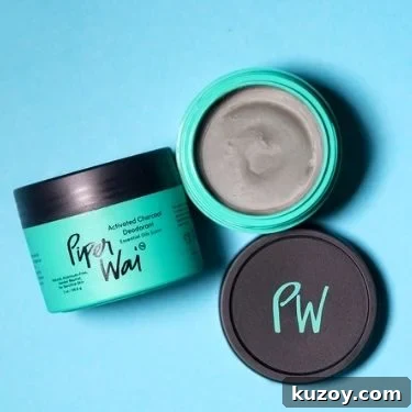 Two containers of Piperwai activated charcoal deodorant cream. One is open and one is on it's side.