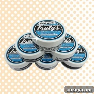 A stack of six containers of Truly's non-toxic deodorant cream in a pyramid shape.