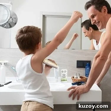 A small child with short hair stands in front of the bathroom sink applying MONA deodorant stick while their father looks on.