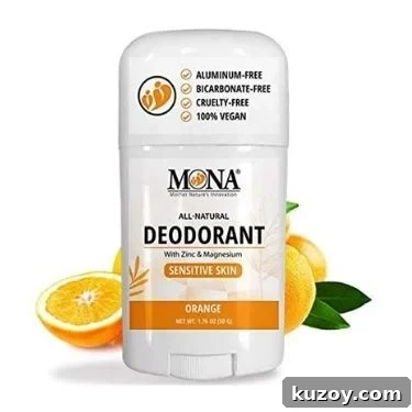 A front view of MONA's all-natural deodorant with zinc & magnesium for sensitive skin in their orange scent. A few oranges are in the background.