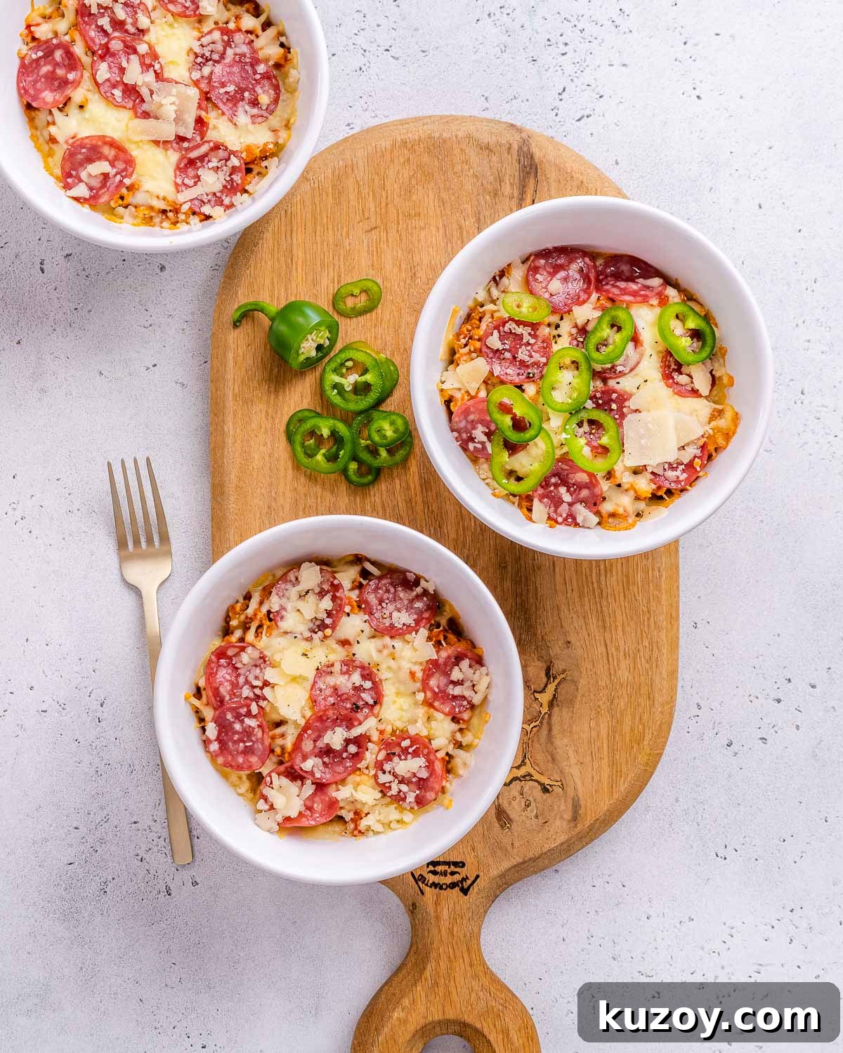 High-Protein Keto Pizza Bowls — Low-Carb Meal Prep 2 Low carb pizza bowls with high protein on a cutting board.